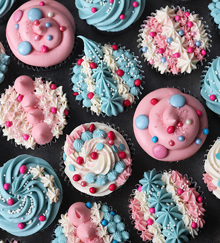 Glutenfree cupcakes for a birthday tea, made with organic Fairtrade ingredients. These are egg-free, topped with cream cheese buttercream swirls and gluten free sprinkles. Delivery in London. All ingredients gluten-free. Vegan and milk-free also available